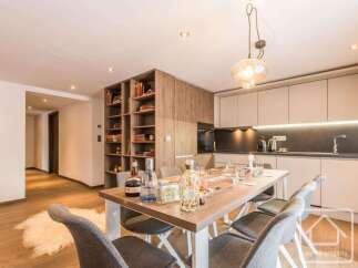 This stunning property boasts a modern kitchen with sleek cabinetry and a cozy dining area, perfect for entertaining.