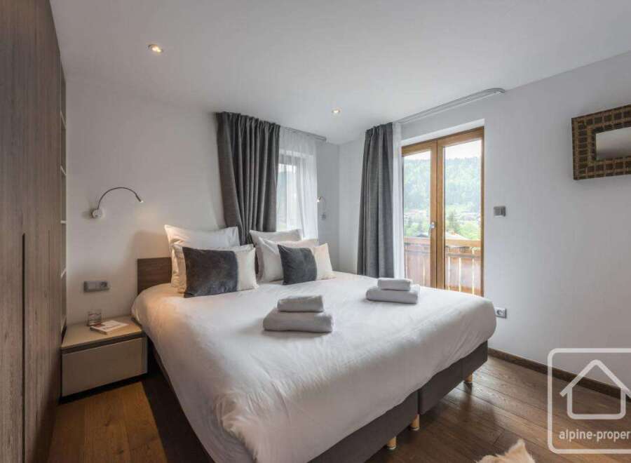 Experience luxury in this stunning bedroom featuring a comfortable bed and elegant decor.