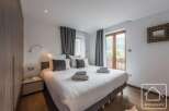 Experience luxury in this stunning bedroom featuring a comfortable bed and elegant decor.
