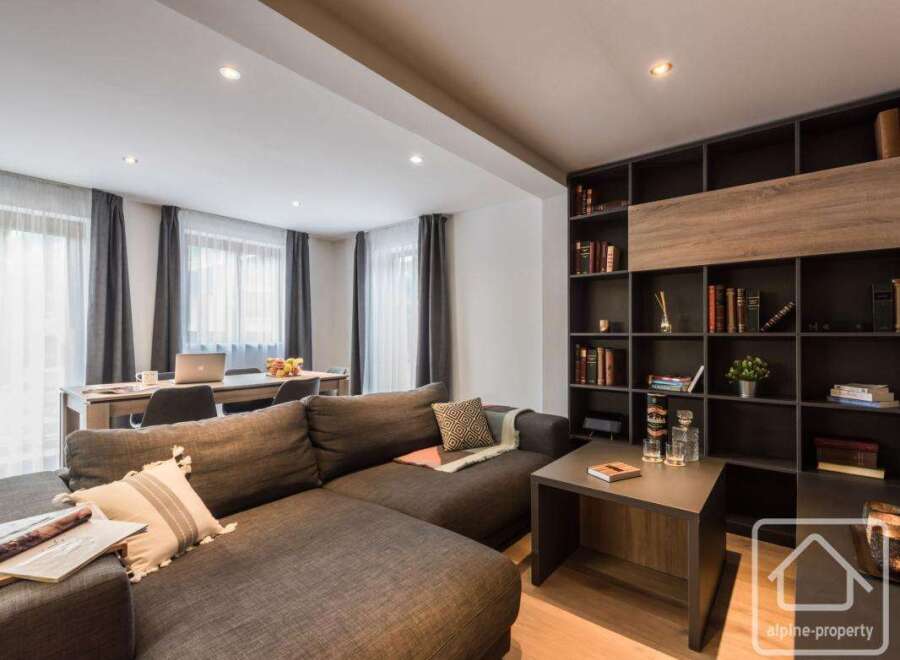 This stunning property boasts a modern living space with a comfortable sectional sofa, perfect for relaxation.