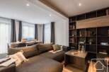 This stunning property boasts a modern living space with a comfortable sectional sofa, perfect for relaxation.