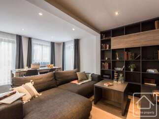 This stunning property boasts a modern living space with a comfortable sectional sofa, perfect for relaxation.