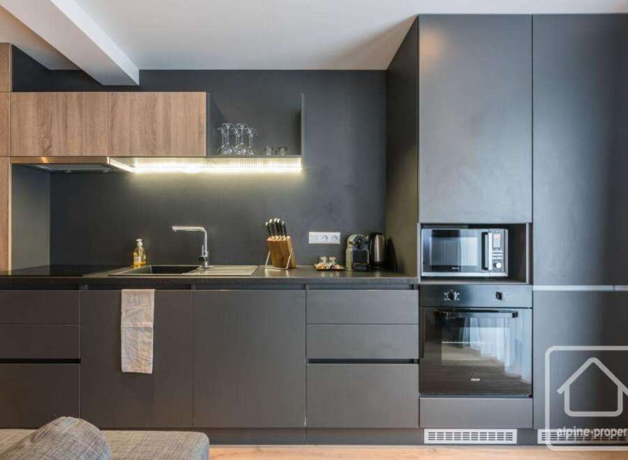 Discover modern living in this stylish kitchen, featuring sleek cabinetry and integrated appliances.