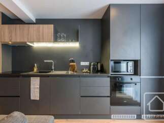 Discover modern living in this stylish kitchen, featuring sleek cabinetry and integrated appliances.