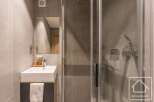 This modern bathroom features a sleek, minimalist design with a glass shower enclosure and a stylish vanity.