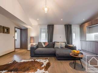 This stunning property boasts a modern living space with a comfortable sectional sofa, perfect for relaxation.
