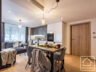 This modern apartment boasts a stylish open-plan living and dining area, perfect for entertaining.