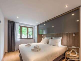 Experience luxury in this stunning bedroom featuring a modern design and ample natural light.