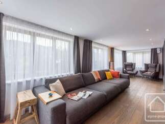 Experience luxury living in this stunning property featuring a spacious living room with a large, comfortable sofa.