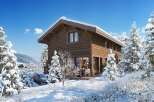 Experience the charm of this stunning wooden cabin nestled in a snowy landscape.