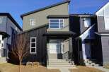 This stunning modern home boasts a unique architectural design with a mix of textures and colors.