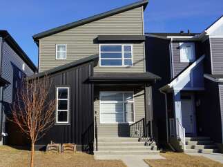This stunning modern home boasts a unique architectural design with a mix of textures and colors.