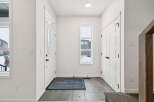 Step into this inviting entryway, featuring a modern design with sleek white doors and walls.