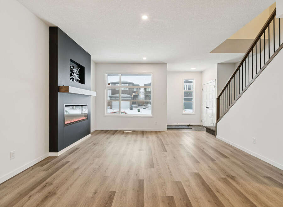 Step into modern elegance with this stunning property! Featuring a sleek, dark accent wall with a built-in fireplace, this home offers a cozy yet sophisticated ambiance.