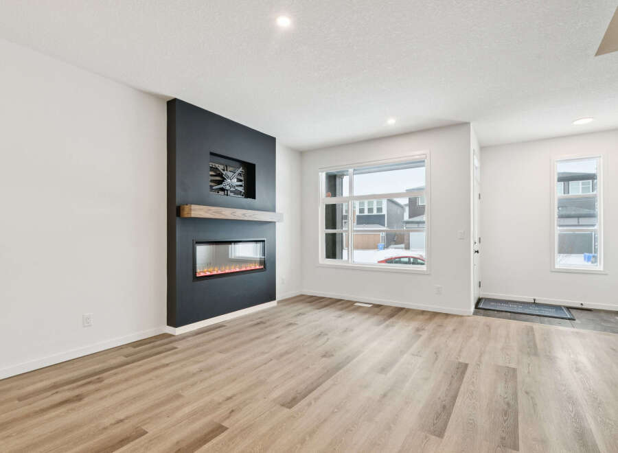 This stunning property boasts a modern living space with a sleek fireplace, perfect for cozy evenings.