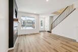 Step into this stunning home featuring a modern fireplace and elegant staircase.