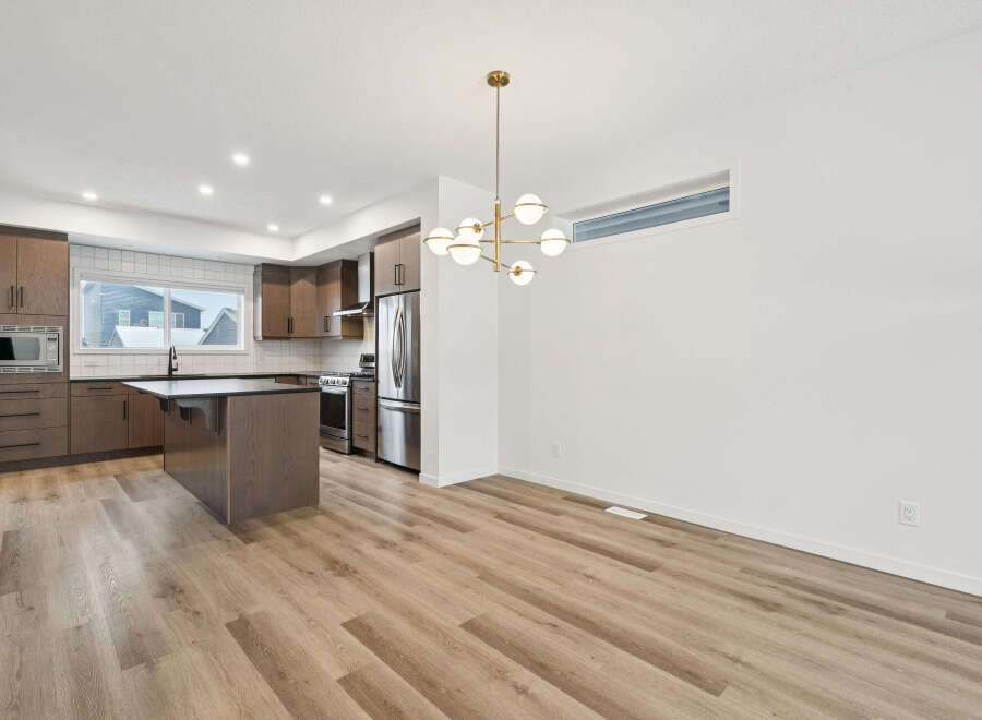 Step into modern elegance with this stunning kitchen and dining area.