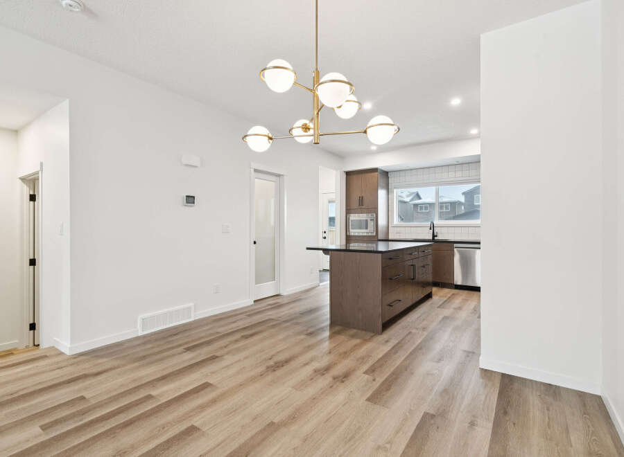 Step into modern elegance with this stunning property! Featuring a beautifully designed kitchen with a stylish island and sleek appliances, perfect for culinary enthusiasts.