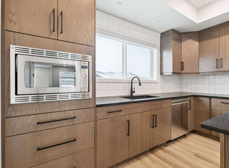 This modern kitchen boasts sleek cabinetry and stainless steel appliances, creating a stylish and functional space.