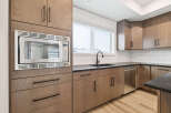 This modern kitchen boasts sleek cabinetry and stainless steel appliances, creating a stylish and functional space.
