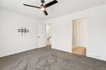 Step into this bright and airy bedroom, featuring a modern ceiling fan and a neutral color palette.