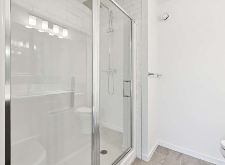 Step into a modern bathroom oasis! This stunning space features a sleek glass shower enclosure, perfect for a refreshing start to your day.