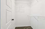 Step into this spacious walk-in closet, offering ample storage with its wire shelving system.