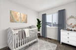 This charming nursery features a stylish crib, perfect for welcoming your little one.