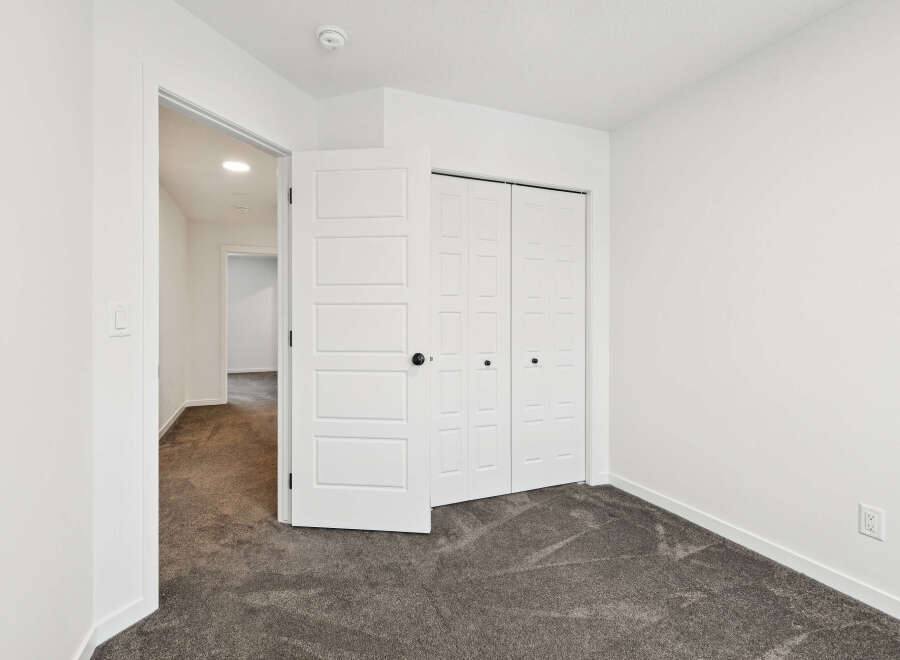 Step into this bright and airy bedroom, featuring a spacious closet and neutral color palette.