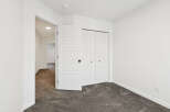 Step into this bright and airy bedroom, featuring a spacious closet and neutral color palette.