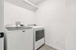 This laundry room features a modern Maytag washer and dryer set, perfect for efficient and stylish laundry days.