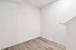 This stunning property boasts a modern interior with pristine white walls and elegant wood-look flooring.