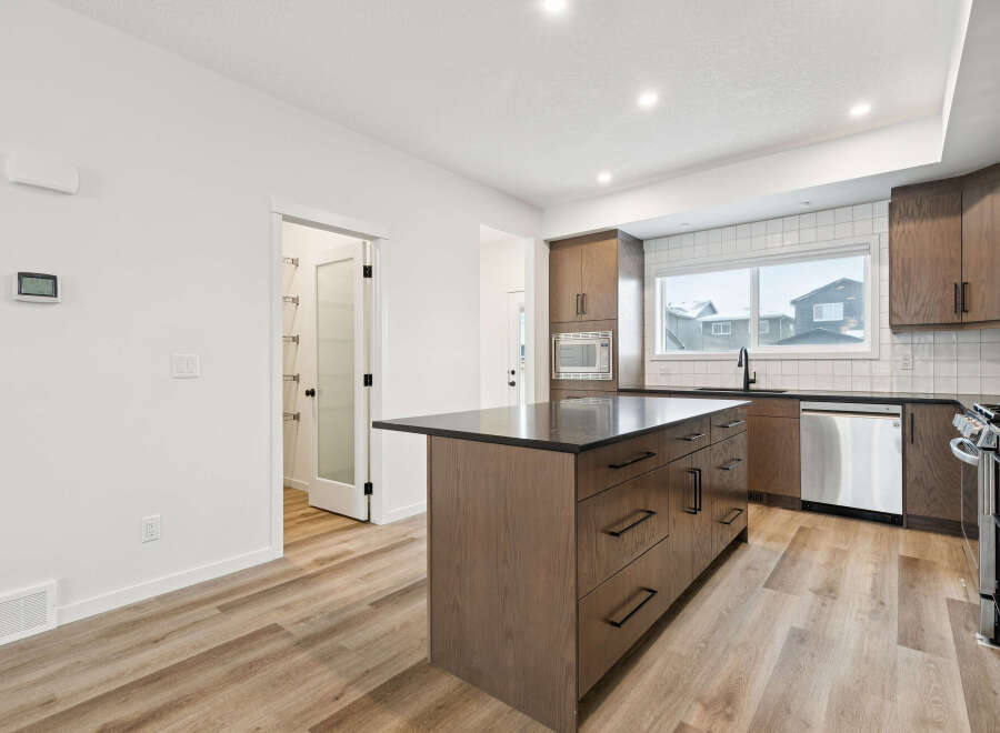 This stunning kitchen boasts a modern design with sleek cabinetry and a spacious island, perfect for both cooking and entertaining.