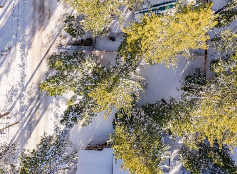 This stunning property offers a serene winter wonderland setting, perfect for those seeking a peaceful retreat.