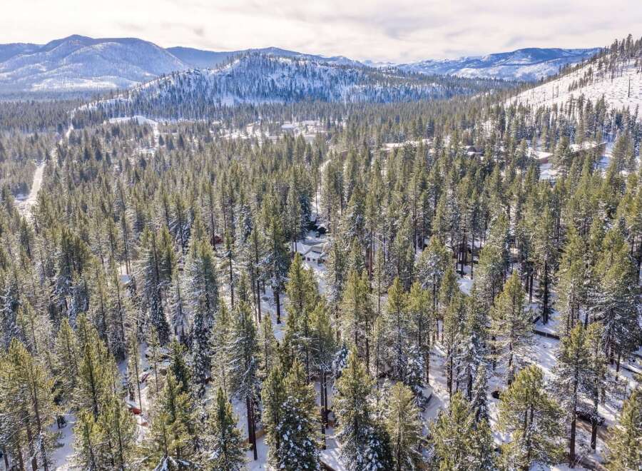 Nestled amidst a serene winter wonderland, this property offers unparalleled privacy and breathtaking views.