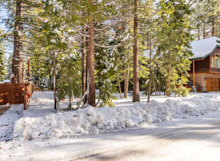 Nestled amidst snow-covered trees, this charming property offers a serene winter escape.