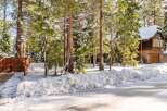 Nestled amidst snow-covered trees, this charming property offers a serene winter escape.