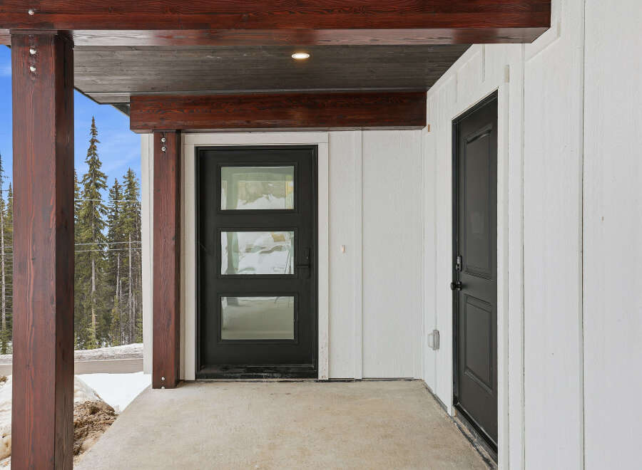 This stunning property features a modern black front door with glass panels, offering a stylish entrance.