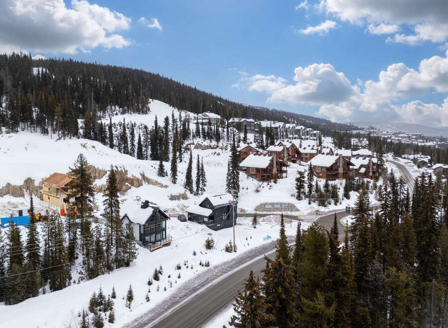 Nestled in a picturesque winter wonderland, this stunning property offers a luxurious escape.