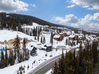 Nestled in a picturesque winter wonderland, this stunning property offers a luxurious escape.