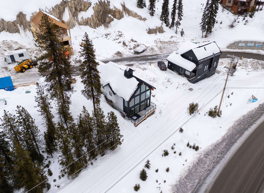 Discover a stunning modern home nestled in a picturesque snowy landscape.