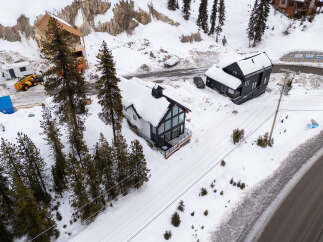 Discover a stunning modern home nestled in a picturesque snowy landscape.