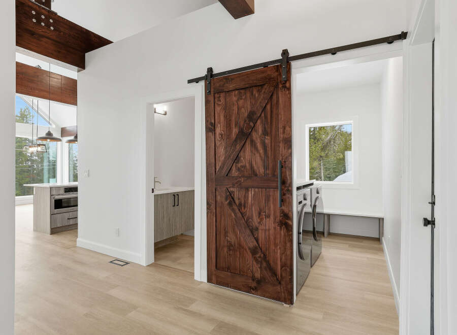 Step into modern elegance with this stunning property featuring a beautifully crafted barn door.