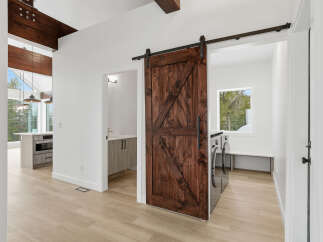 Step into modern elegance with this stunning property featuring a beautifully crafted barn door.