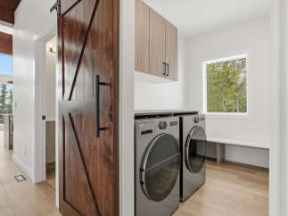This stunning laundry room features a modern design with a touch of rustic charm.