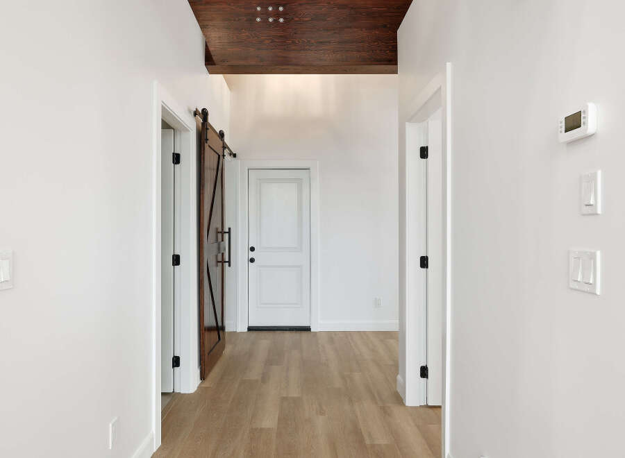 Step into this stunning hallway, showcasing a blend of modern and rustic design elements.