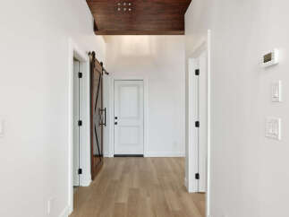 Step into this stunning hallway, showcasing a blend of modern and rustic design elements.