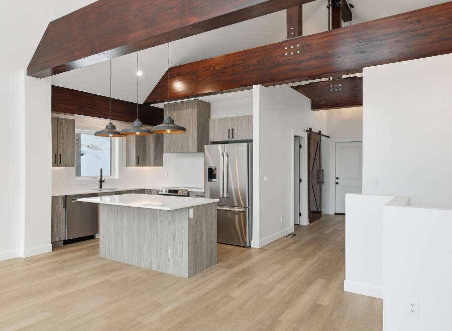 This stunning kitchen boasts a modern design with sleek cabinetry and a spacious island, perfect for both cooking and entertaining.