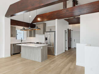 This stunning kitchen boasts a modern design with sleek cabinetry and a spacious island, perfect for both cooking and entertaining.