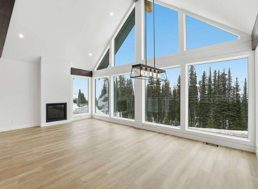 This stunning property boasts a bright and airy living space, highlighted by expansive windows that offer breathtaking views of the surrounding natural landscape.